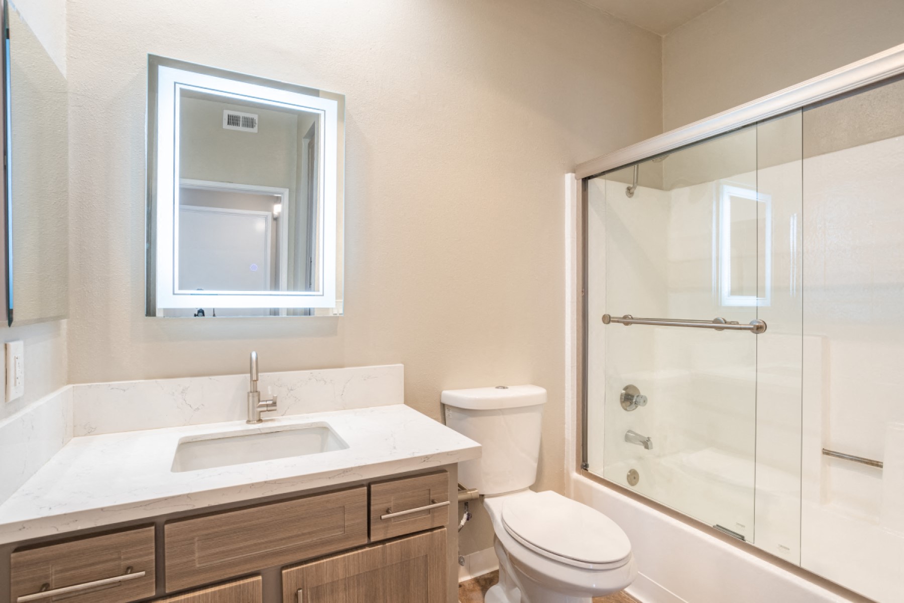 a bathroom with a toilet sink and a shower