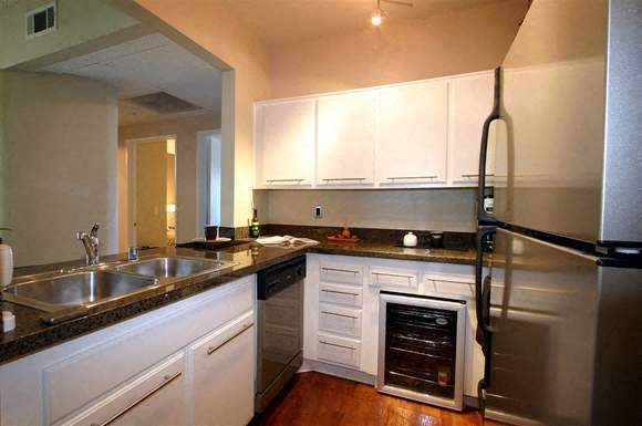 a kitchen with stainless steel appliances and white cabinets