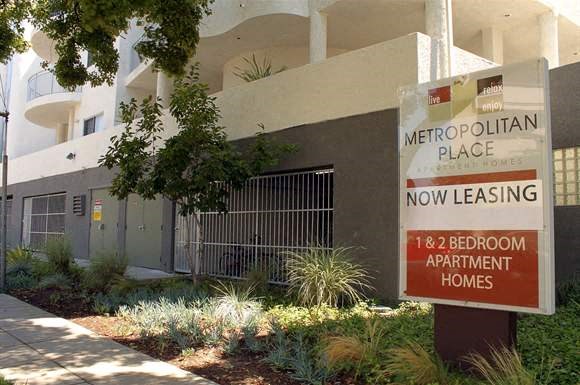 a sign in front of an apartment building