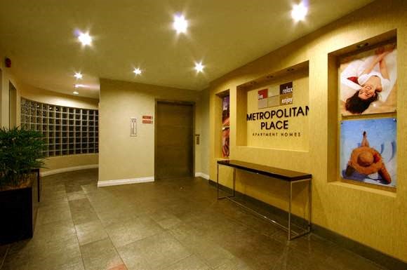 the lobby of the metropolitan place with a reception desk
