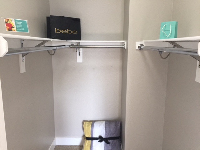 a closet with a shelf and a stool in it