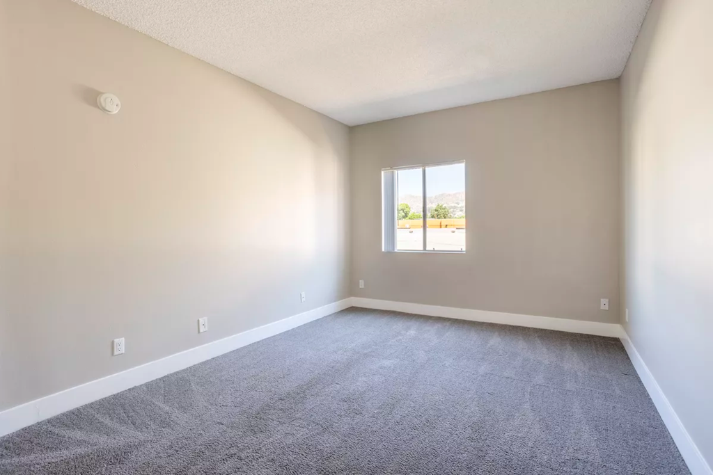 an empty living room with a window