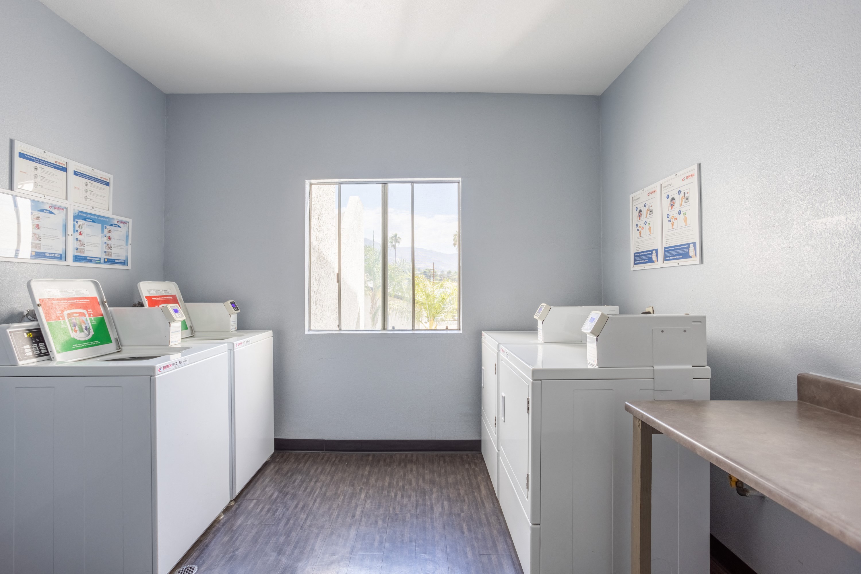 an empty room with white appliances and a window