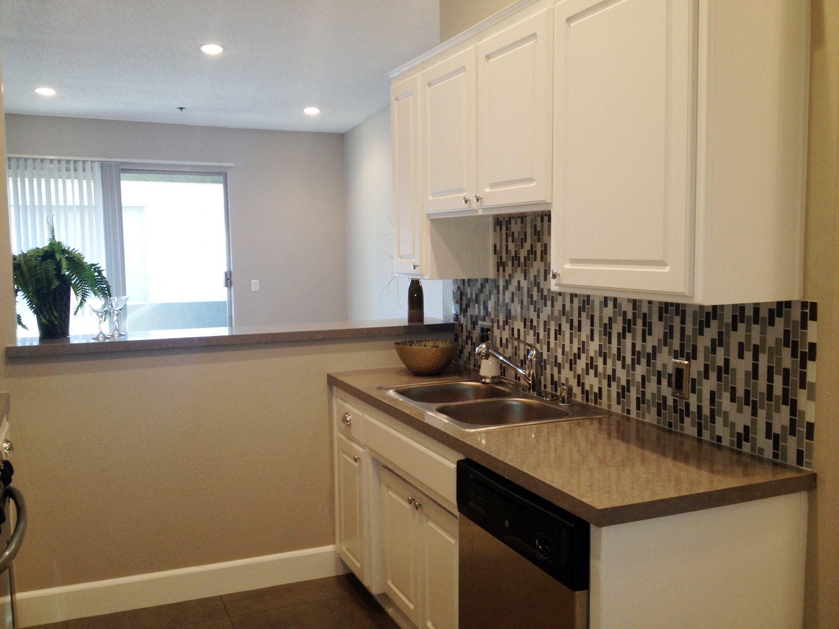 a kitchen with white cabinets and a sink