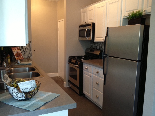 a kitchen with stainless steel appliances and a sink