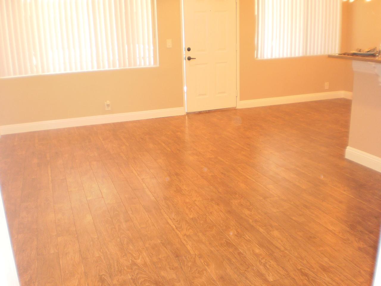 a living room with a wooden floor and a door