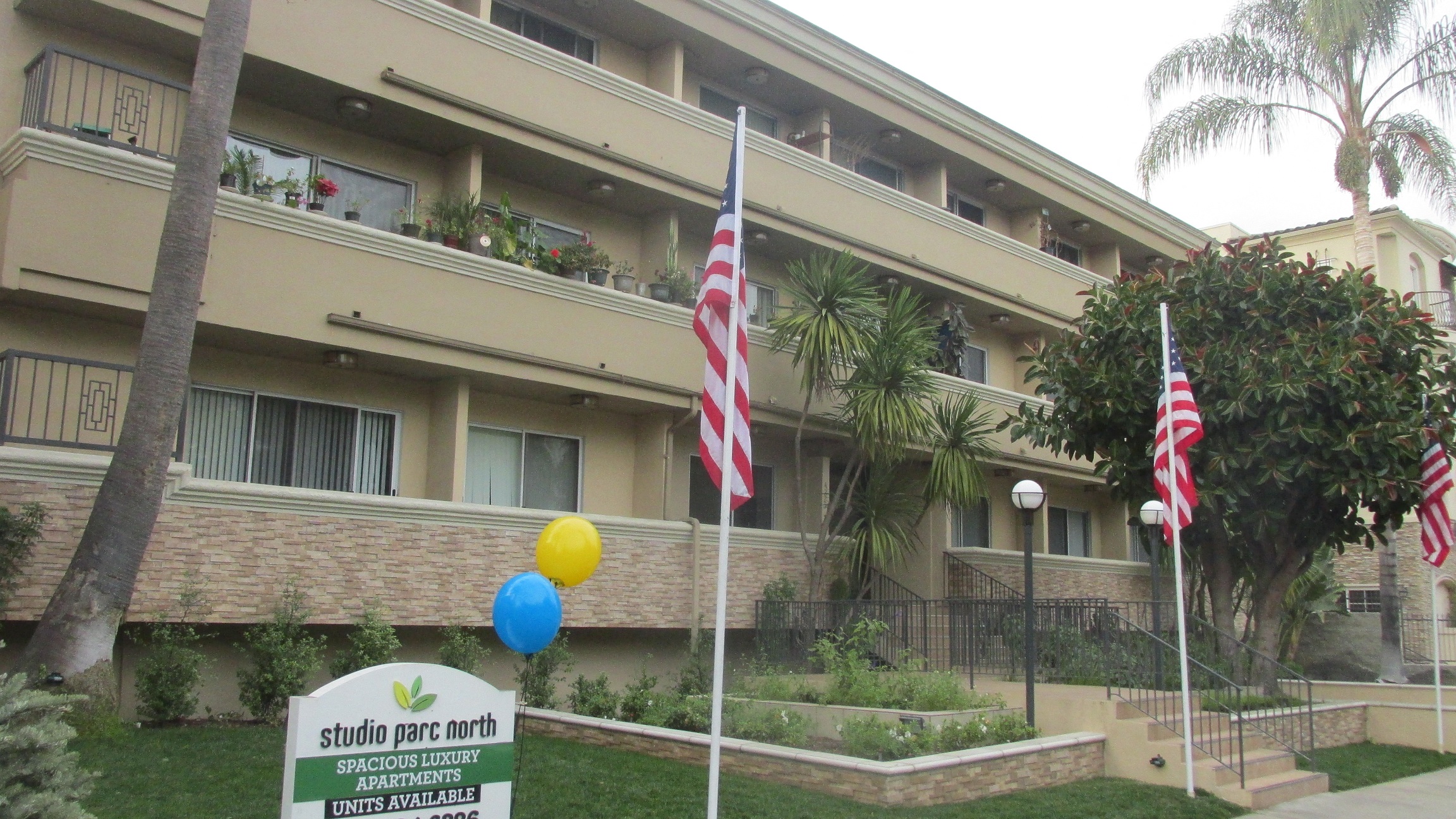 the front of our building with flags and balloons