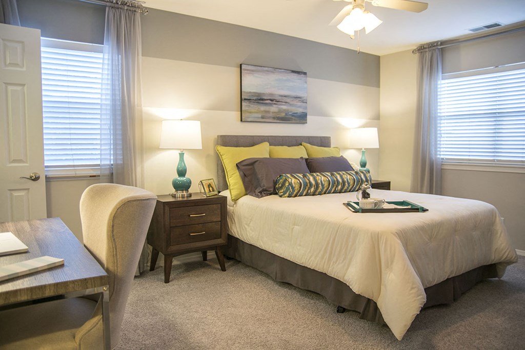 a bedroom with a bed and a desk