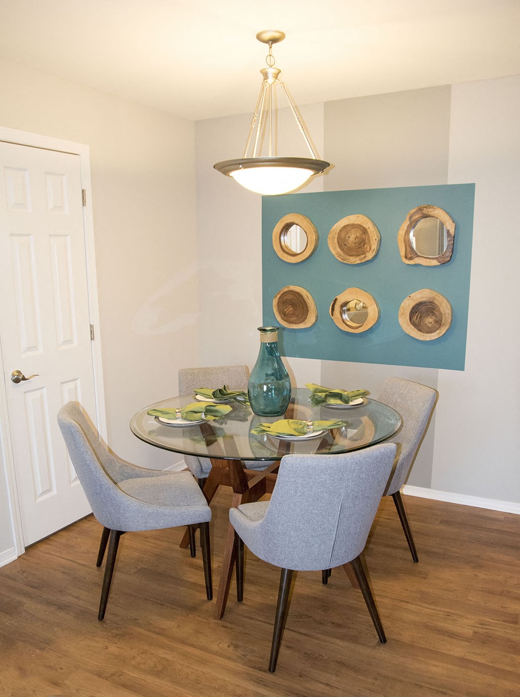 a dining room with a glass table and chairs