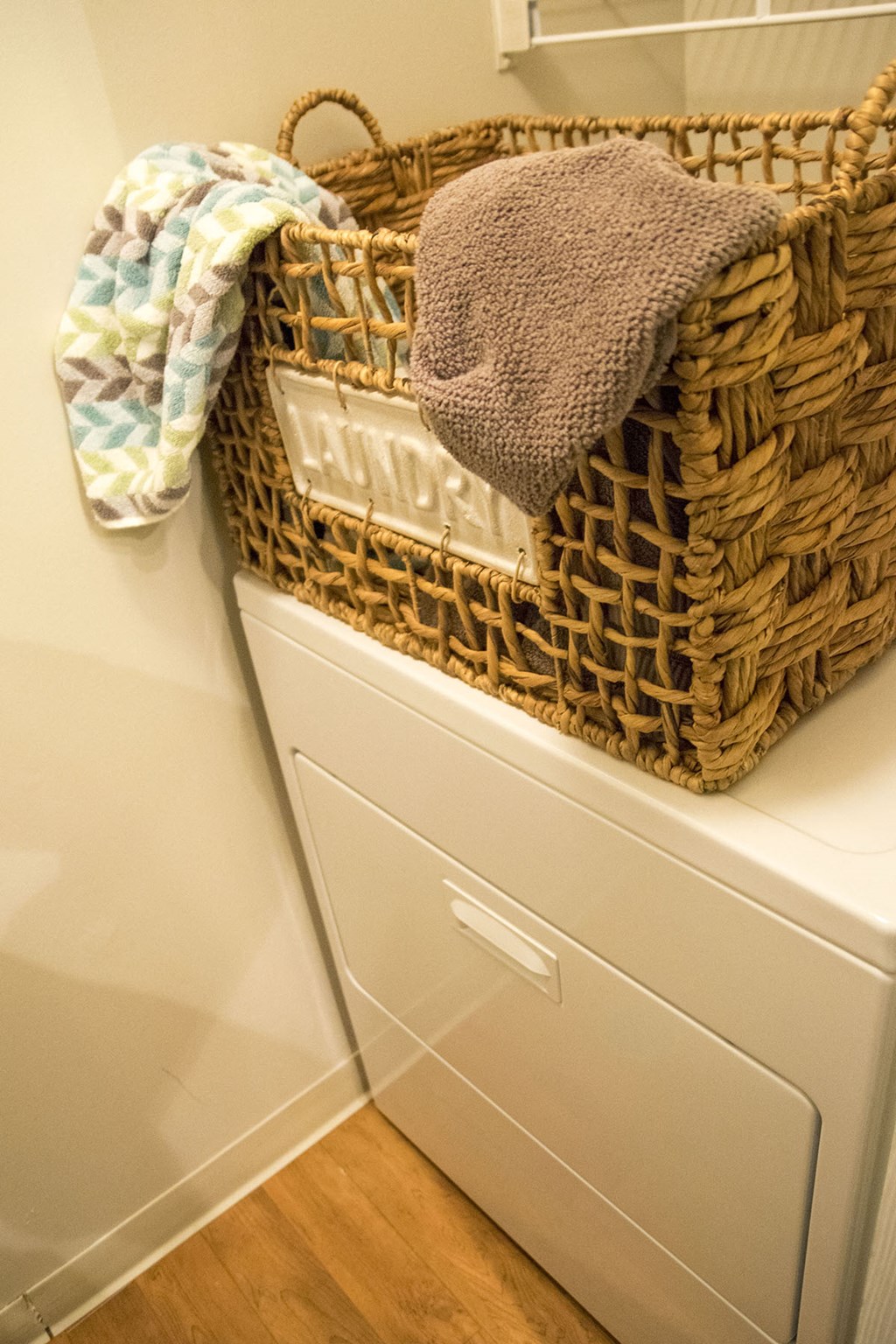 a basket on top of a washing machine in a bathroom