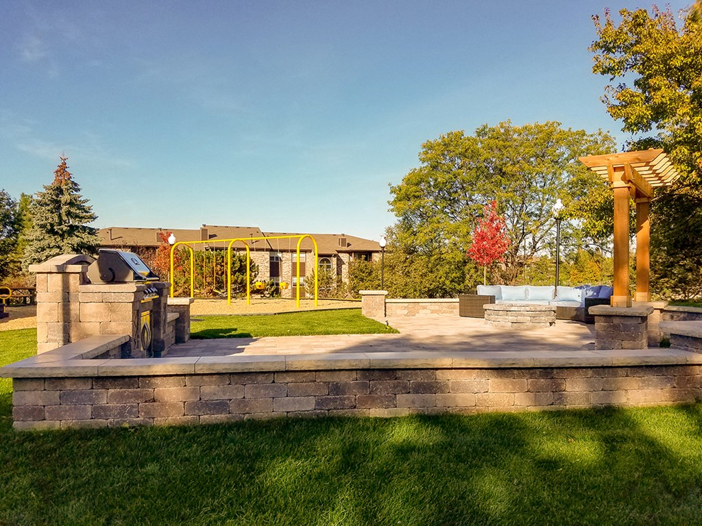 a park with a fountain and a building in the background