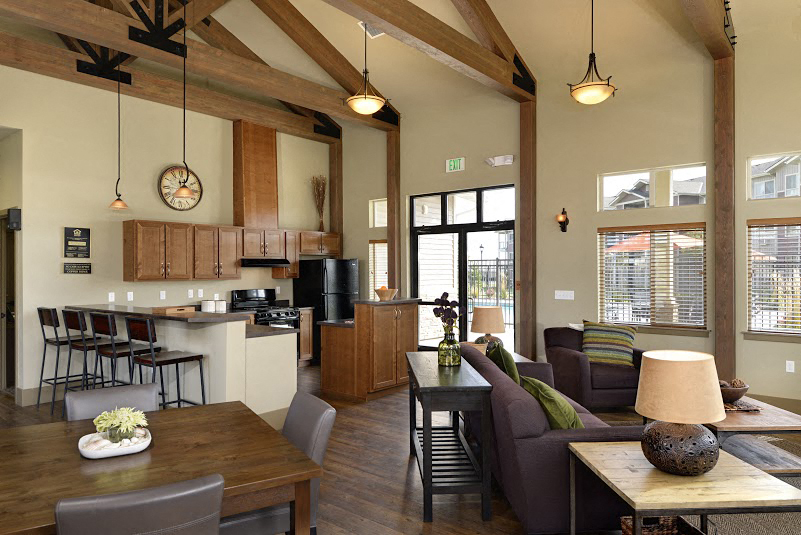 A modern kitchen with wooden cabinets and a dining table with chairs.
