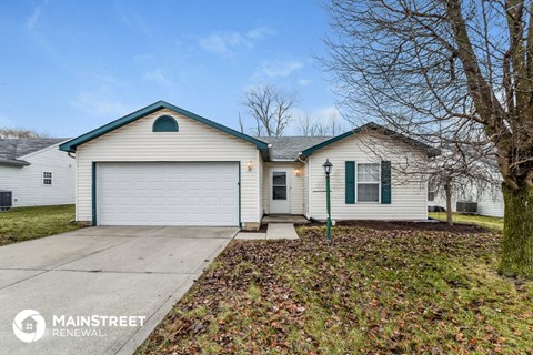 a white house with a white garage door and a sidewalk