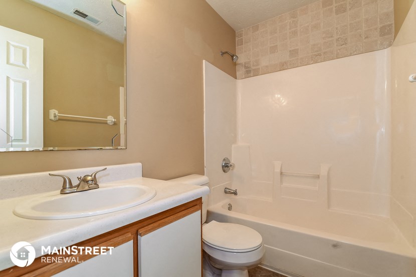 a bathroom with a sink toilet and a shower