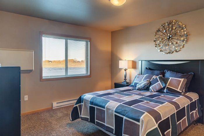 a bedroom with a bed and a window