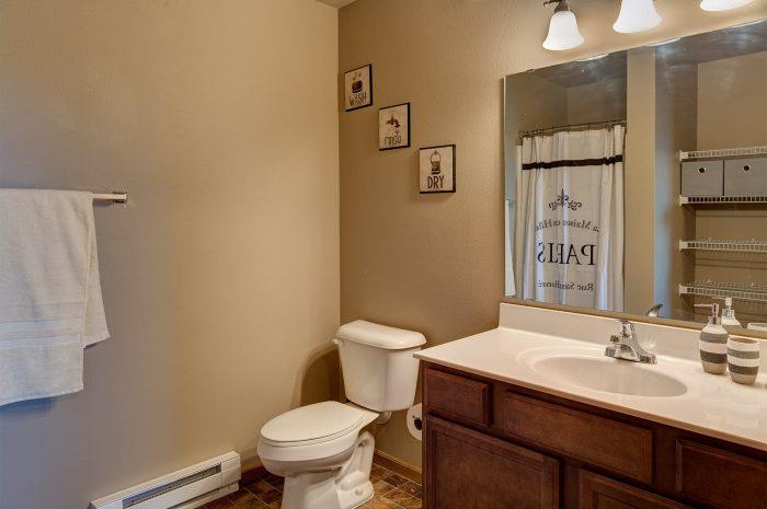 a bathroom with a sink toilet and a mirror