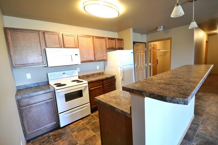 a kitchen with white appliances and granite counter tops