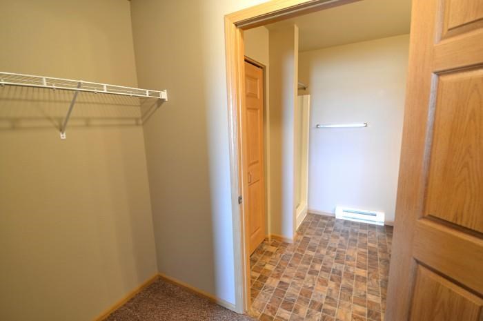 a hallway with a closet and a door to a bathroom
