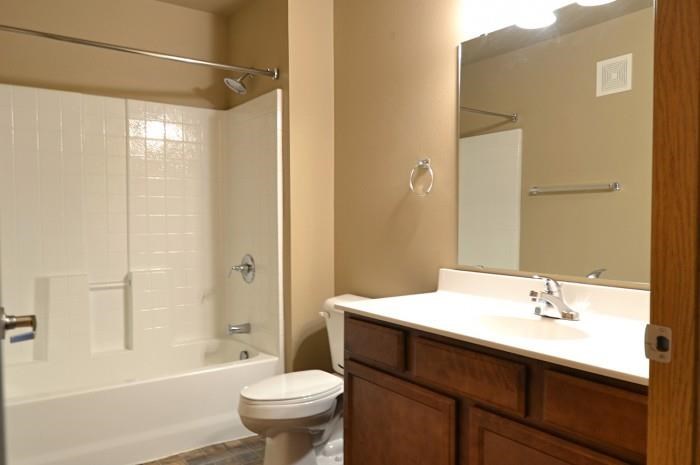 a bathroom with a toilet and a sink and a shower