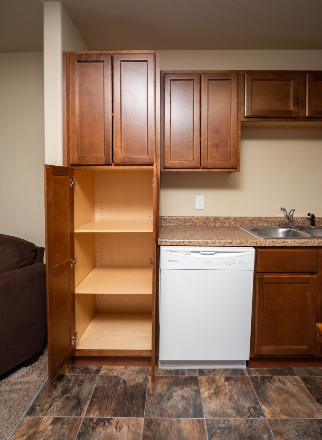 a kitchen with a cabinet and a sink and a dishwasher