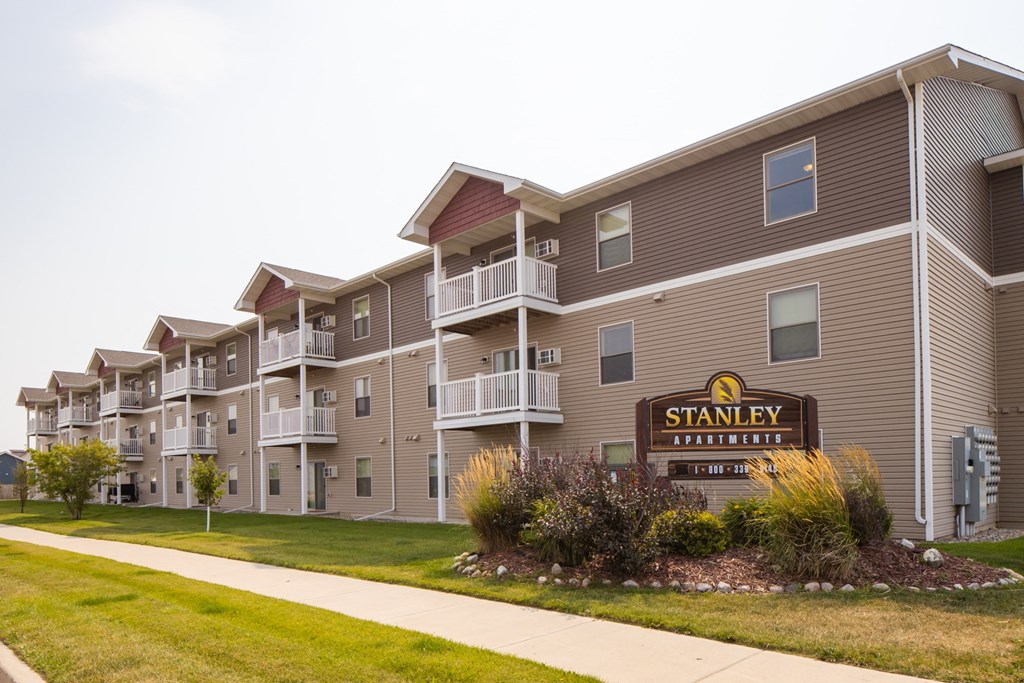 an exterior view of an apartment building with a sign for stamen trail apartments