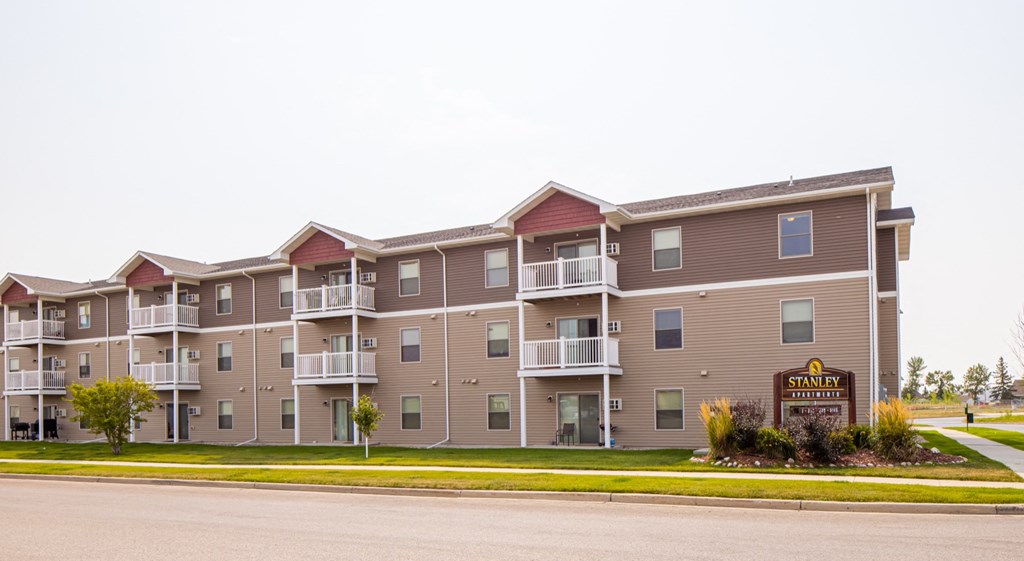 an image of an apartment building on the side of a street