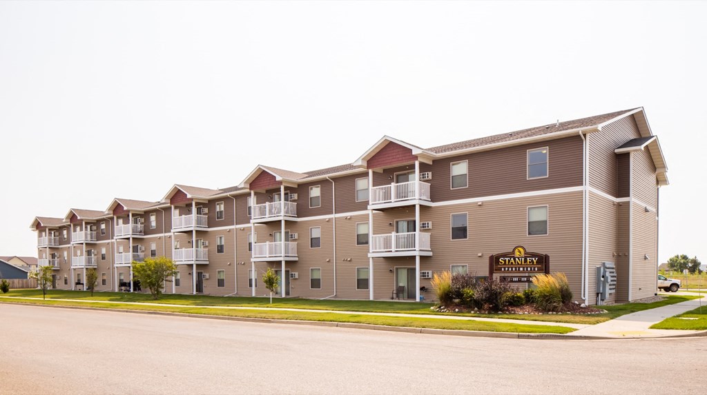 an exterior view of an apartment building on a street