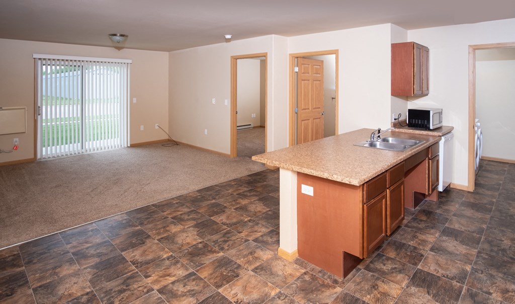 an empty kitchen and living room in a house
