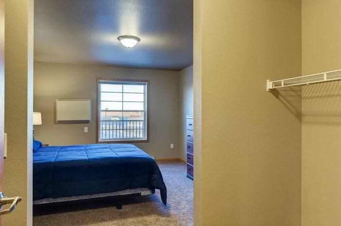 a bedroom with a bed and a closet