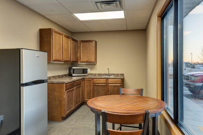 a kitchen with a small table and a refrigerator