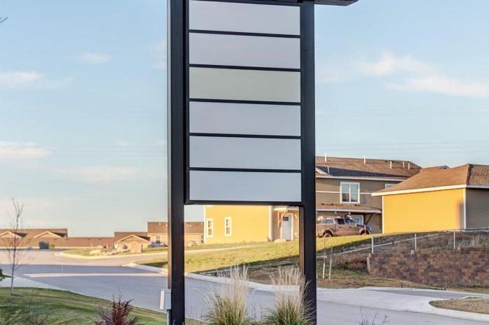 a street sign with houses in the background