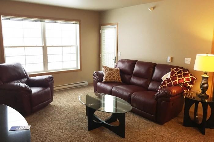 a living room with leather couches and a coffee table