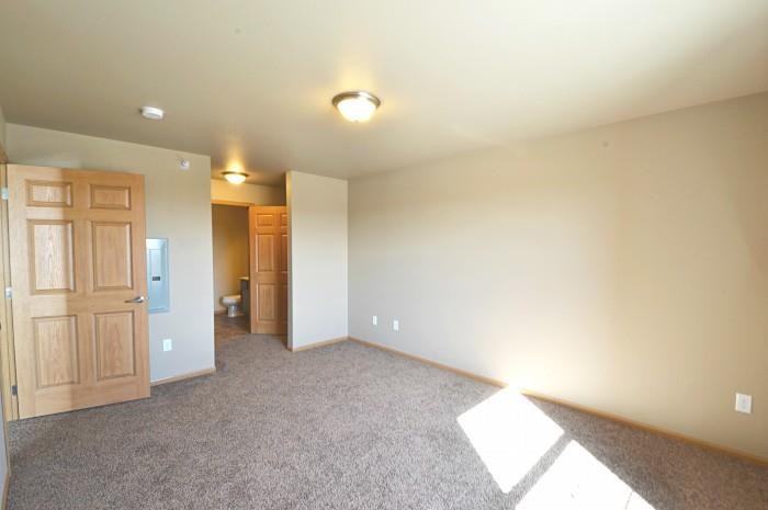 an empty living room with a wooden door