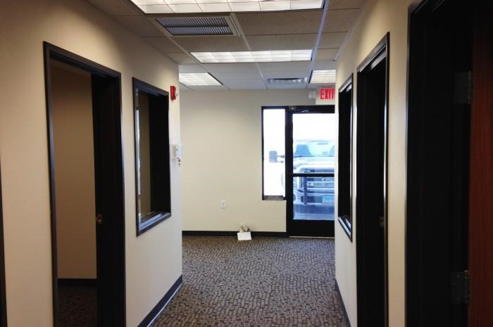 a hallway with doors and windows in a room