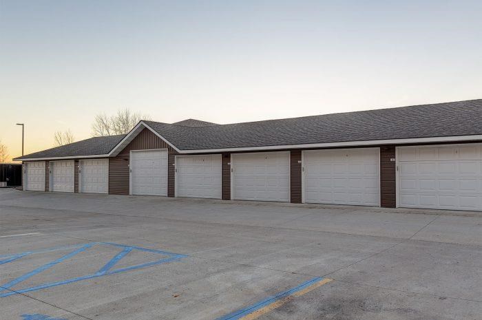 a row of garage doors in a parking lot