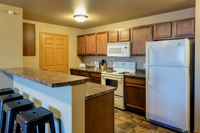 a kitchen with a white refrigerator and a counter top
