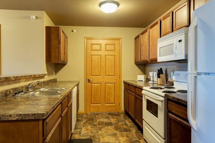 a kitchen with a stove refrigerator and a sink