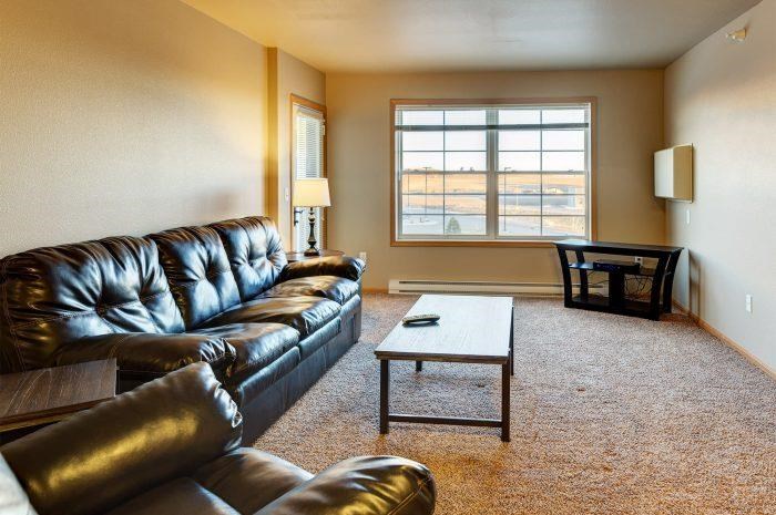 a living room with a leather couch and a coffee table