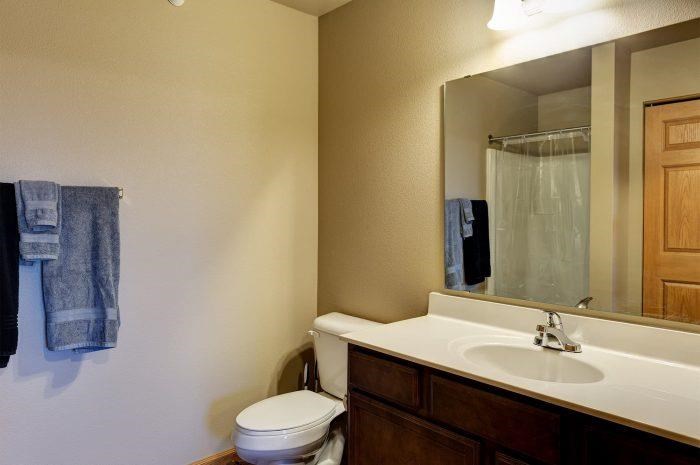 a bathroom with a sink toilet and a mirror