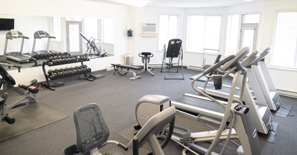 a gym with a variety of exercise equipment