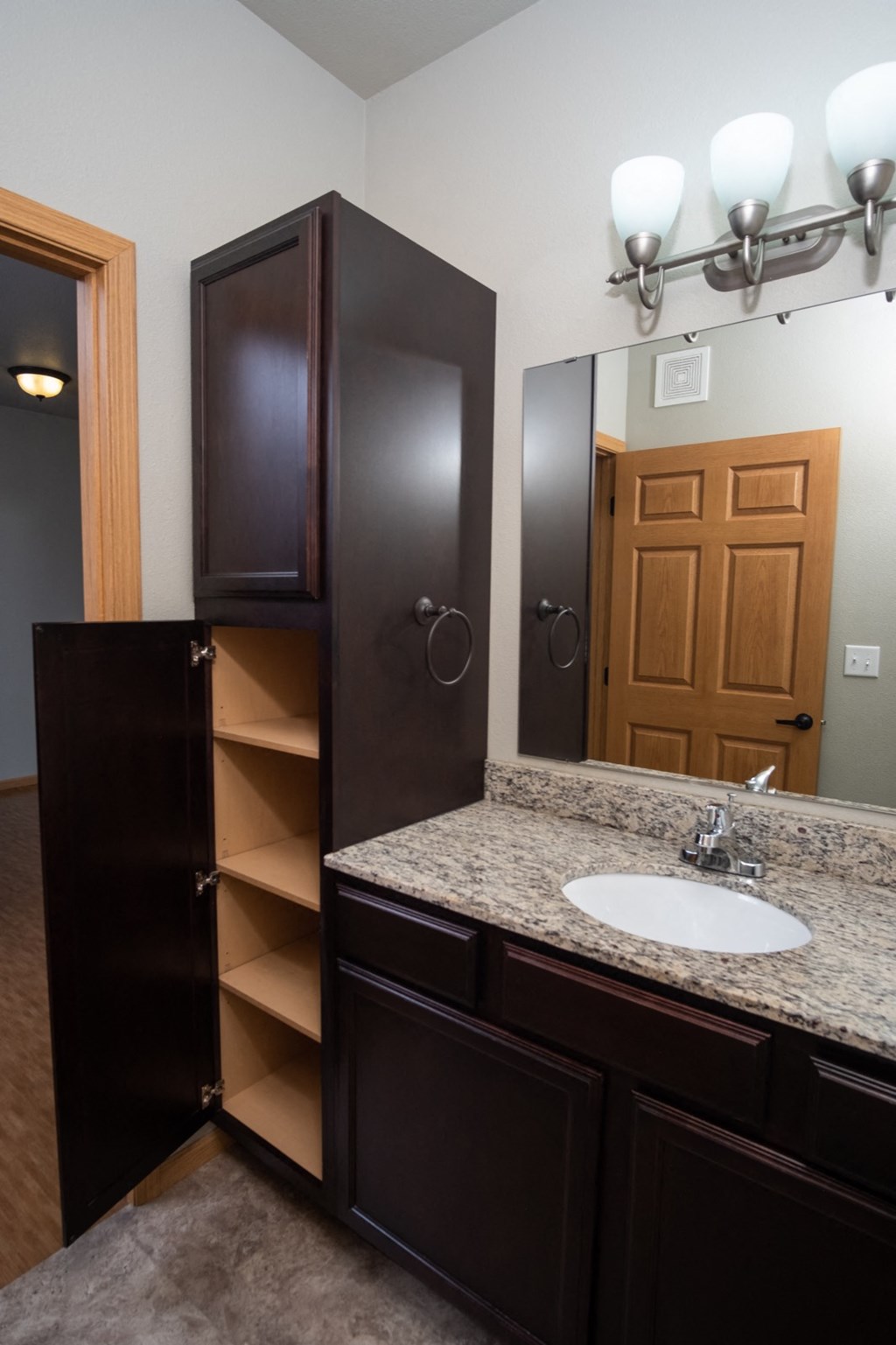 a bathroom with a sink and a mirror and a closet