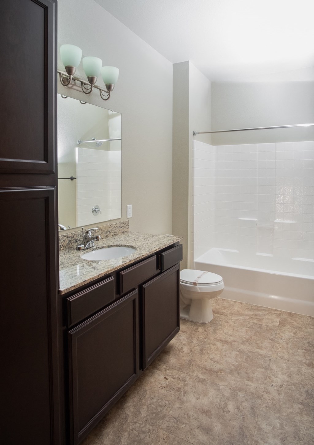 a bathroom with a toilet and a sink and a shower