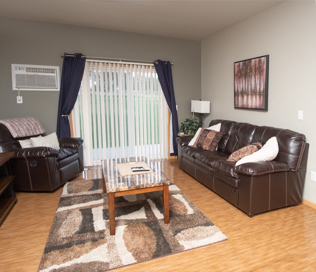 a living room with leather couches and a coffee table