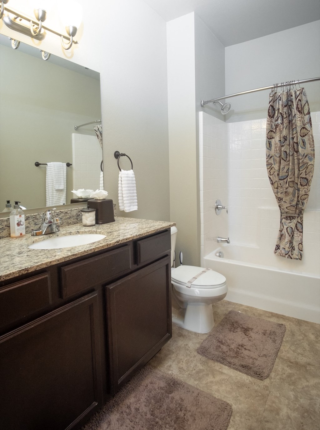a bathroom with a toilet and a shower and a sink