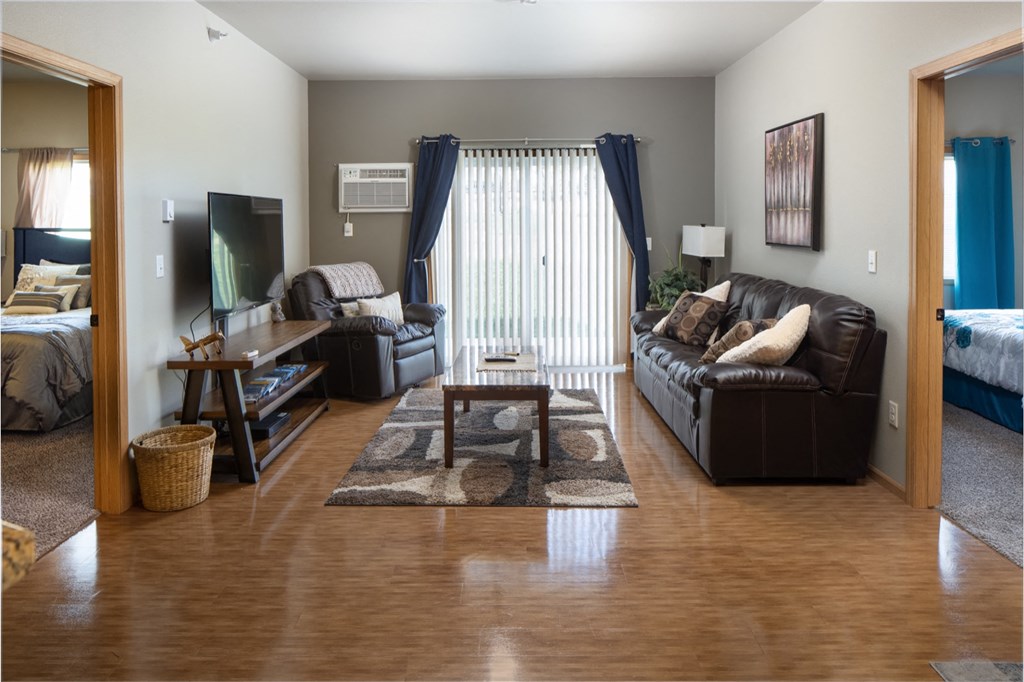 a living room with a leather couch and a tv