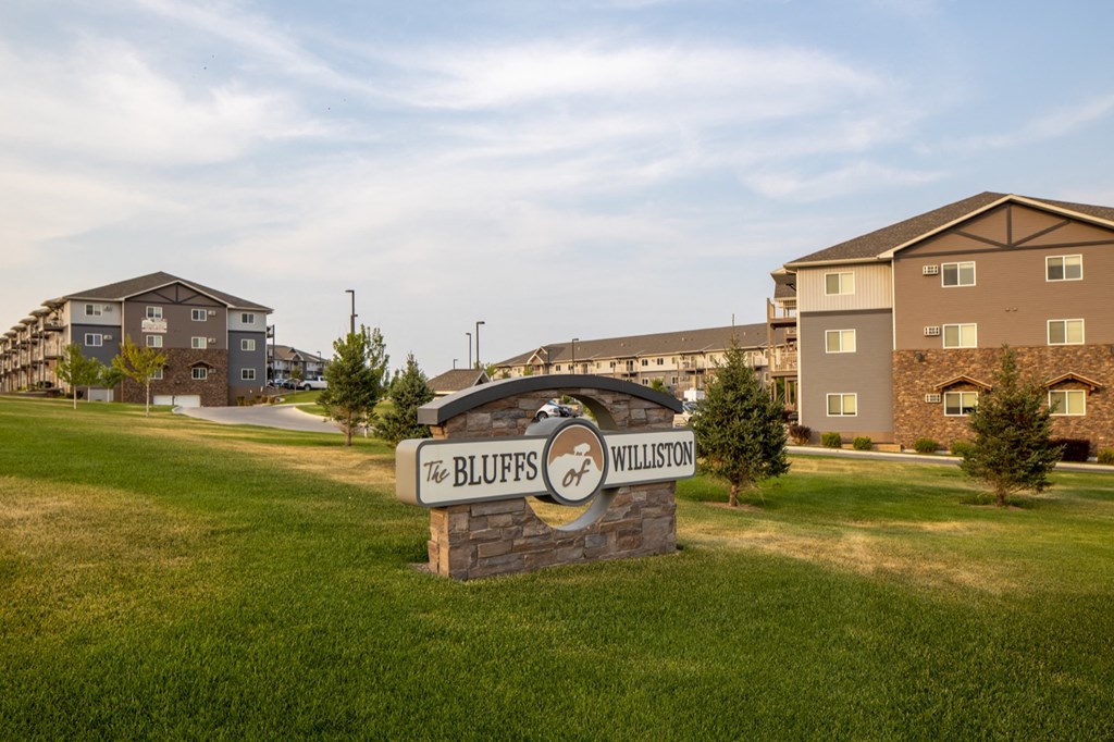 the residences sign with apartment buildings in the background