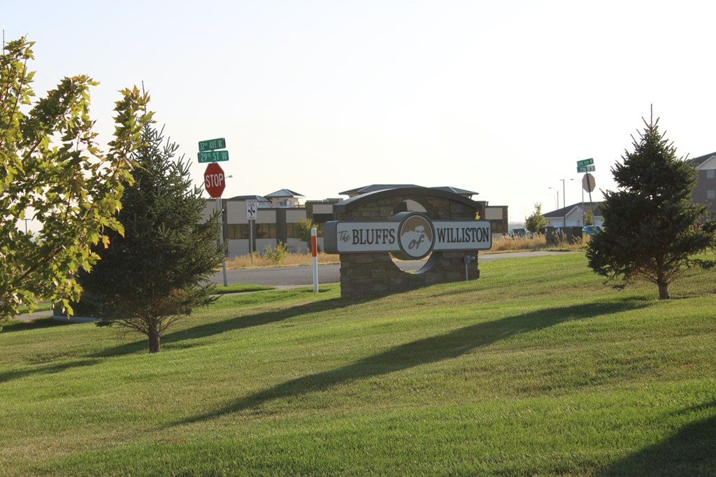 a sign in the middle of a grass field