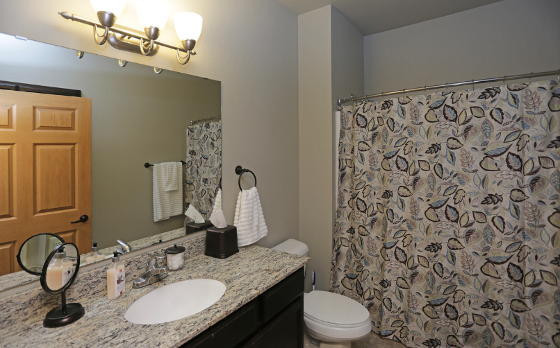 a bathroom with a sink and a shower and a toilet