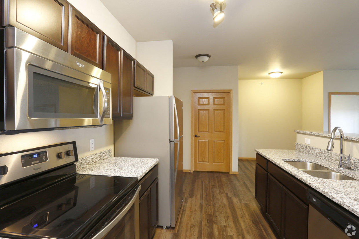 full kitchen with stainless steel appliances and granite counter tops in an apartment