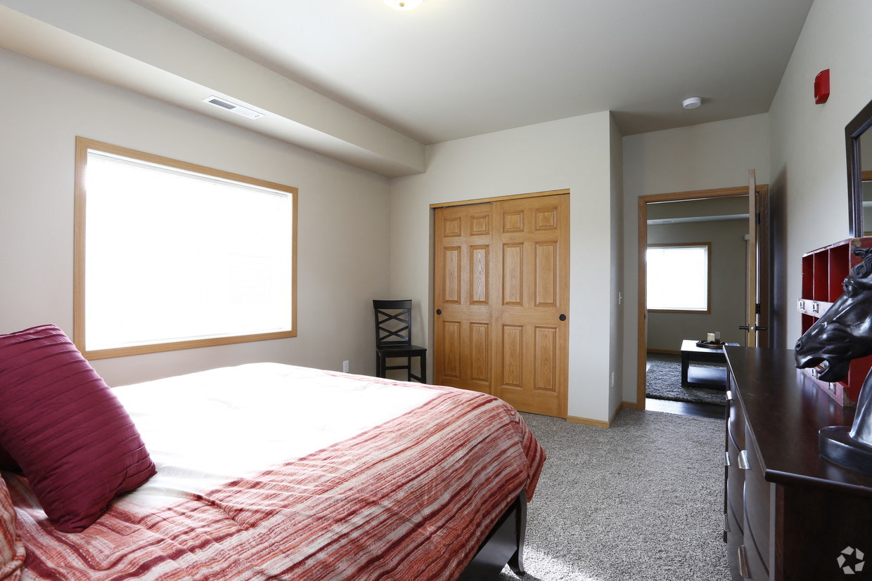 a bedroom with a bed and a wooden door